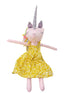 Stuffed unicorn doll with a yellow dress on a white background