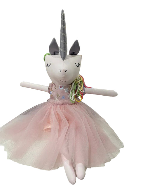 Unicorn plush toy with a pink dress on a white background