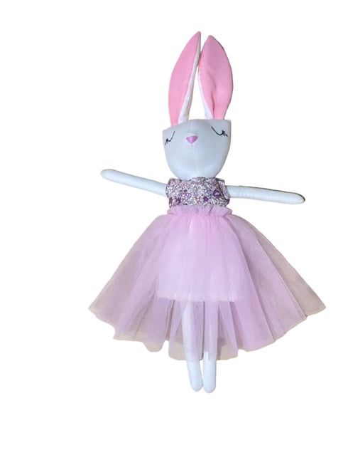 Stuffed bunny toy with a pink dress on a white background