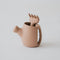 Brown watering can with a unique handle shaped like a hand on a light gray background.