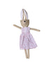 Handmade rabbit doll with a floral dress on a wooden surface