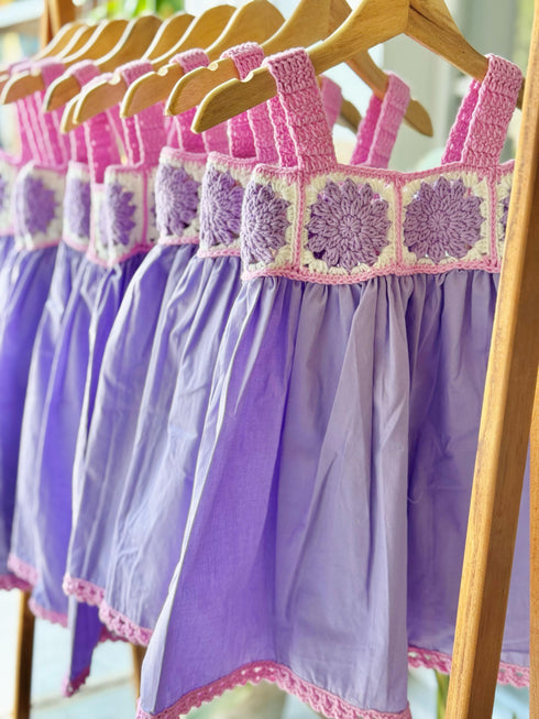 Lilac dress with crochet details on the chest.