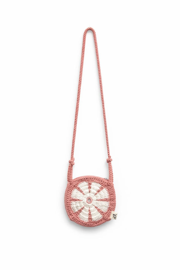 Pink beaded handbag with a circular design on a white background