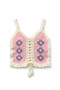 Crocheted pink and white top with floral patterns on a white background