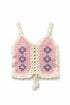 Crocheted pink and white top with floral patterns on a white background