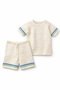 Knitted baby outfit with short-sleeve shirt and shorts on a white background