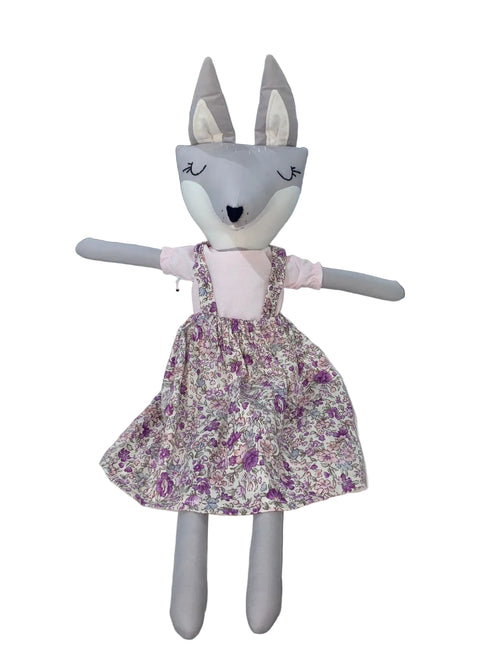 Stuffed animal toy with a floral dress on a white background