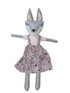 Stuffed animal toy with a floral dress on a white background