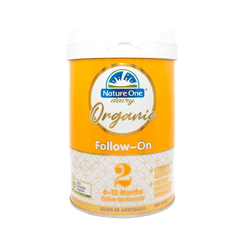 A container of Nature One Dairy Organic Baby Formula Step 2 Follow-On, indicating it is suitable for 6-12 month old infants.
